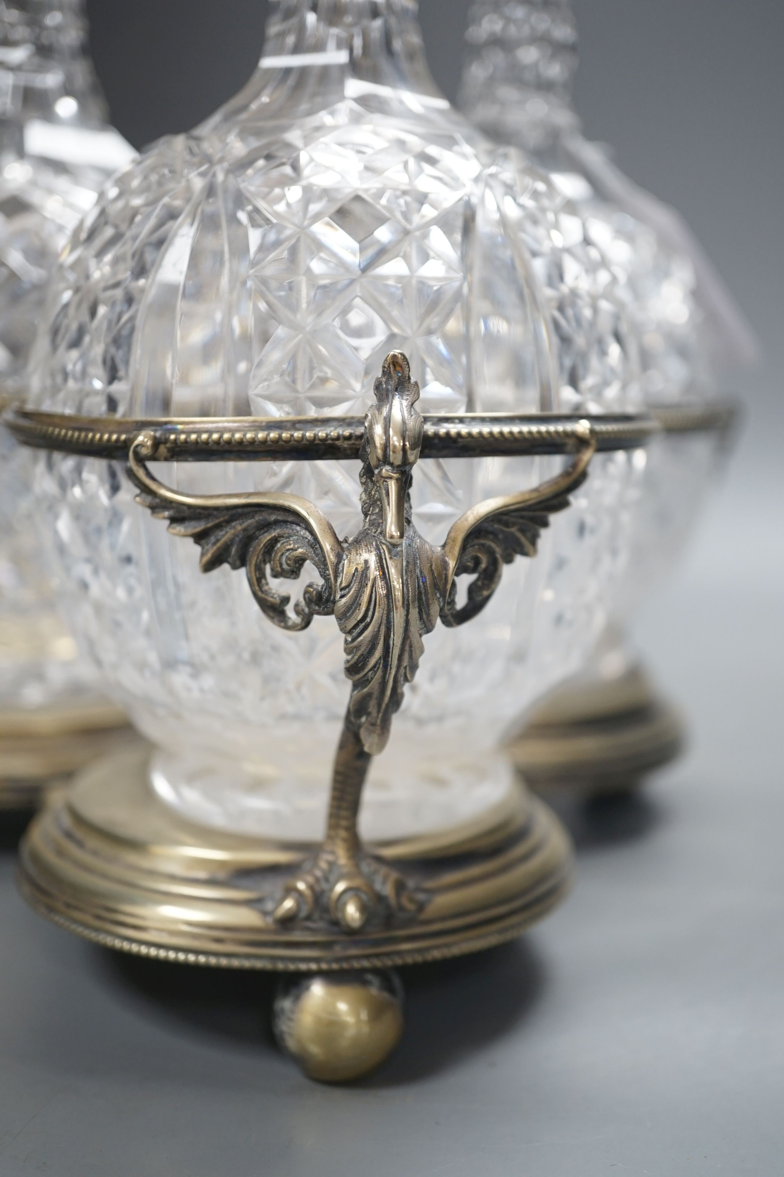 A Victorian plated decanter stand and three cut glass decanters, 34 cms high.